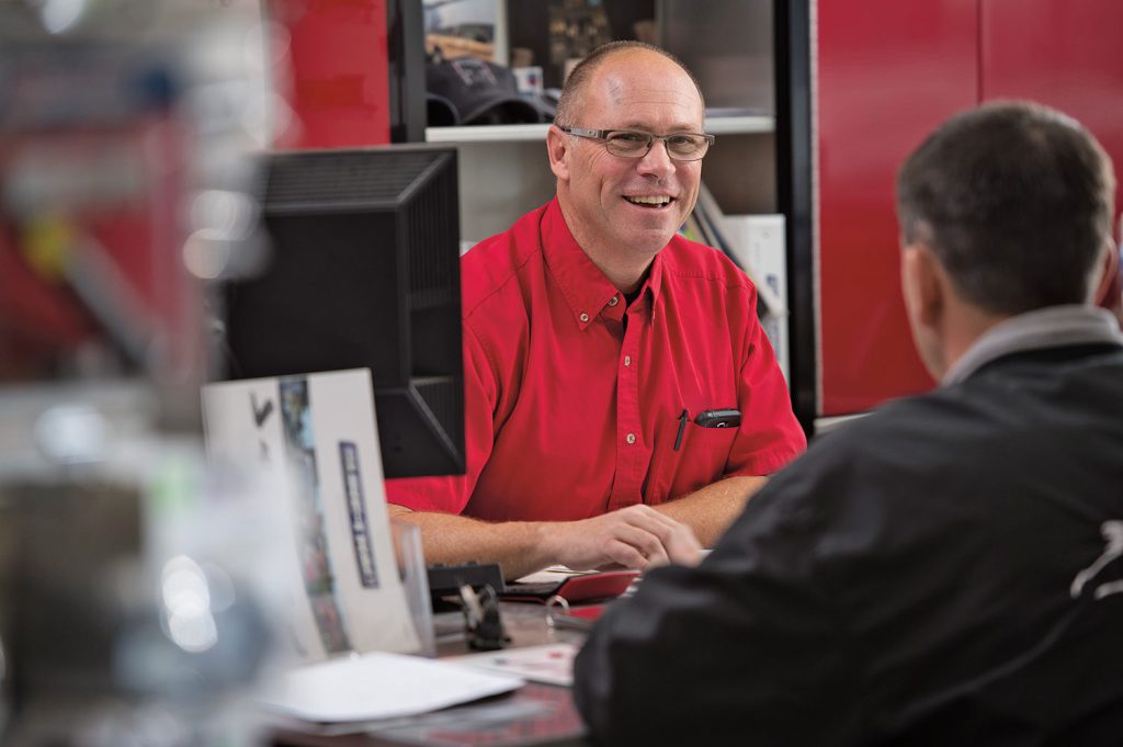 man wearing a red shirt in the sure-trac office 